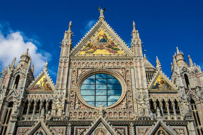 Low angle view of duomo di siena against sky