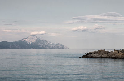 Scenic view of sea and mountains against sky