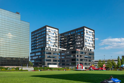 Buildings in city against clear blue sky