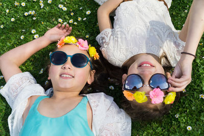 High angle view of happy girl lying on meadow