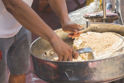 Midsection of man preparing food in kitchen