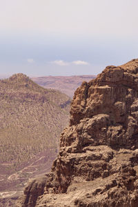 Rock formations on landscape against sky