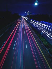 High angle view of light trails on highway at night