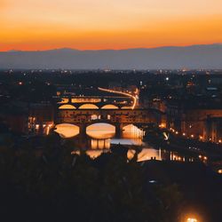Illuminated cityscape against sky at night