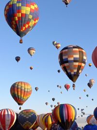Low angle view of colorful hot air balloons against clear sky