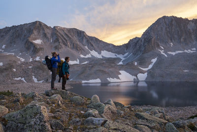 Women hikers watch sunset from pierre lakes, elk mountains, colorado