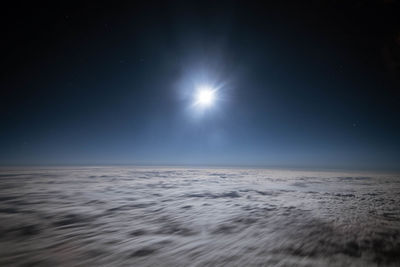 Scenic view of sea against clear sky at night