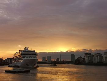 View of sea against buildings during sunset