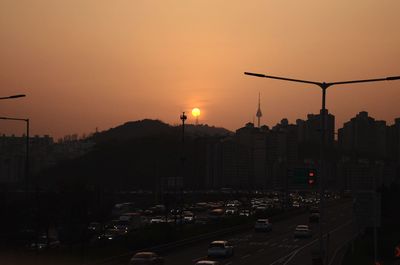 Traffic on road at sunset