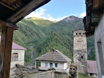 Houses on mountain against sky