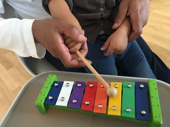 High angle view of hands playing piano