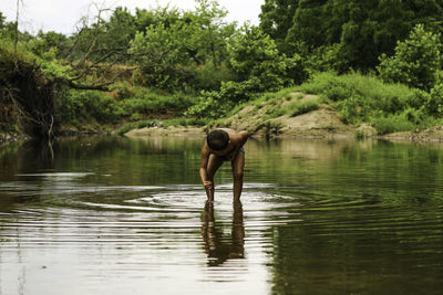 Front view of small boy playing in a creek