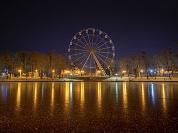 Illuminated ferris wheel at night