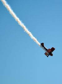 Low angle view of airplane propeller in clear blue sky