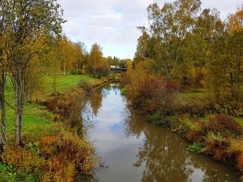 Scenic view of lake by trees against sky during autumn