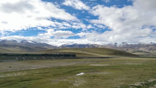 Scenic view of landscape against cloudy sky