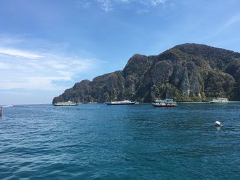 Scenic view of sea and mountains against sky