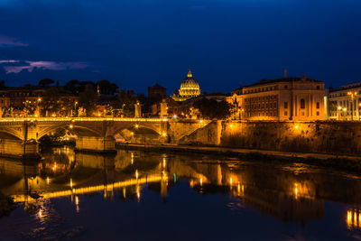 Rome- view over river tiber to vatican state. illuminated buildings in city at night