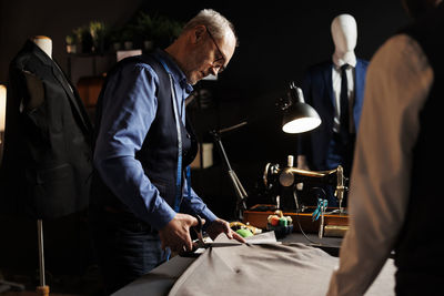 Midsection of man working at workshop