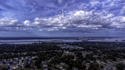 Panoramic view of sea and cityscape against sky