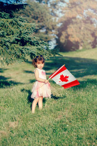 Portrait of cute girl standing on field