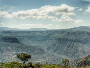 Scenic view of mountains against cloudy sky