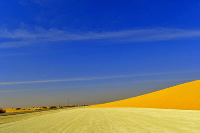 Scenic view of landscape against blue sky