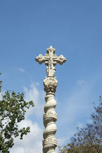 Low angle view of statue against blue sky