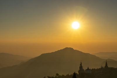Silhouette of temple against sky during sunset