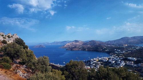 Scenic view of sea and mountains against sky