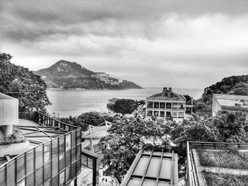 High angle view of buildings by sea against sky