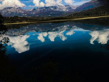 Scenic view of lake and mountains against sky