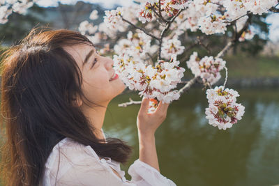 Portrait of young woman with red flowers