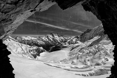 Scenic view of snow covered mountains against sky