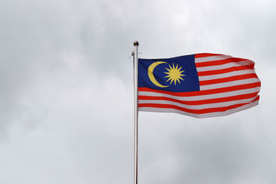 Low angle view of malaysian flag against sky