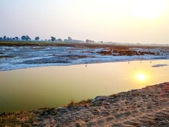 Scenic view of sea against clear sky during sunset