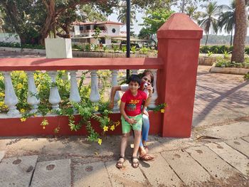 Full length of boy standing on footpath