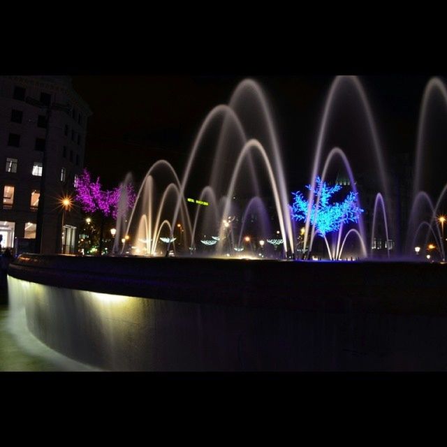 illuminated, night, long exposure, lighting equipment, glowing, reflection, dark, light - natural phenomenon, architecture, motion, fountain, built structure, light trail, light, arts culture and entertainment, building exterior, city, water, multi colored, copy space