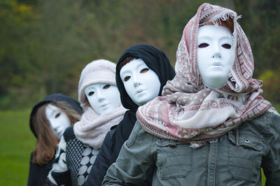 Women covering face with mask at public park