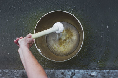 Vibrating tibetan singing bowl is floating on water 