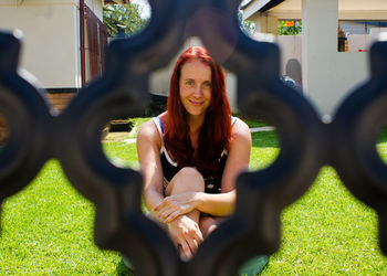 Portrait of smiling young woman sitting outdoors
