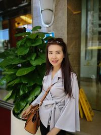 Portrait of young woman standing outdoors