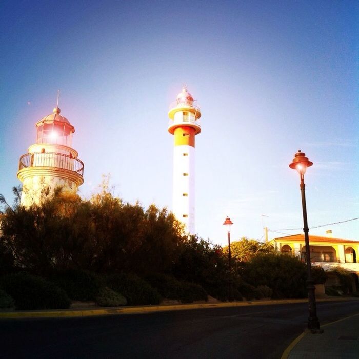 architecture, built structure, building exterior, blue, clear sky, guidance, tower, road, lighthouse, copy space, direction, the way forward, street, sky, street light, communications tower, travel destinations, communication, road sign, low angle view