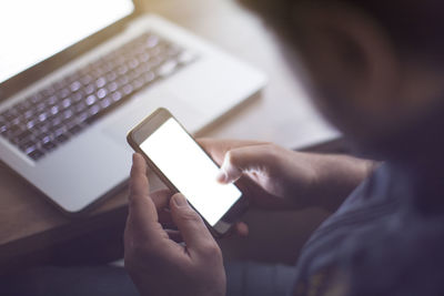 Midsection of woman using mobile phone