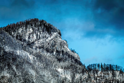 Low angle view of snow covered mountain against sky