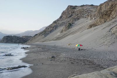 Rear view of people walking on beach