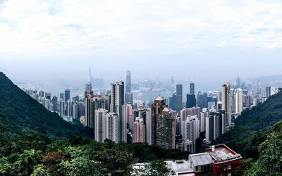 View of cityscape against cloudy sky
