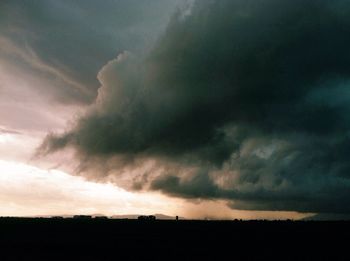 Scenic view of field against cloudy sky