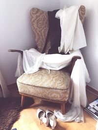 Wedding dress on armchair at home