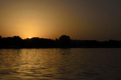 Scenic view of lake against sky during sunset